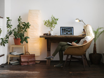 Young woman working in relaxed home office completing taxes