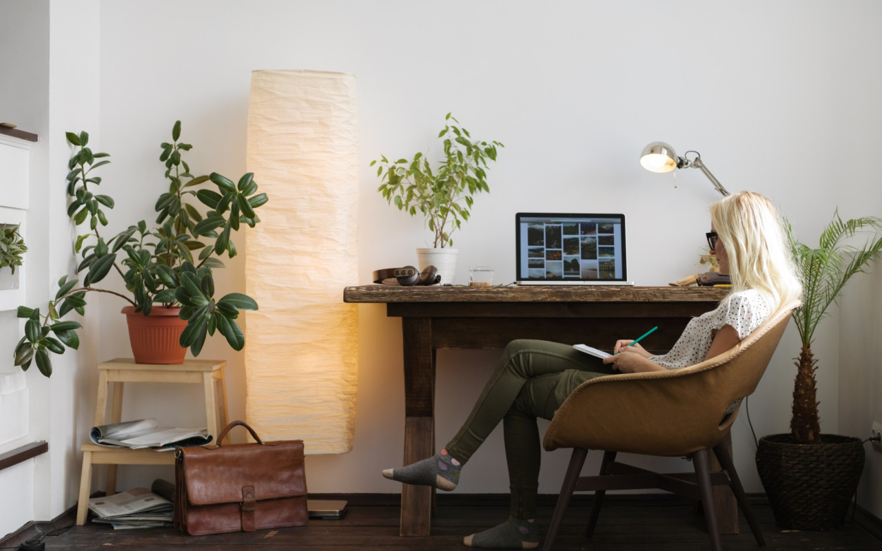Young woman working in relaxed home office completing taxes
